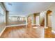 Open-concept living room with hardwood floors, archways, and staircase leading to the second floor at 257 Via Franciosa Dr, Henderson, NV 89011