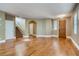 Spacious living area with hardwood floors, stairway, and entryways to other parts of the home at 257 Via Franciosa Dr, Henderson, NV 89011