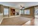 Spacious living room with a built-in entertainment center, fireplace, and sliding door to the patio at 257 Via Franciosa Dr, Henderson, NV 89011