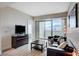 Inviting living room featuring hardwood floors, comfortable seating, and a sliding glass door to a private balcony at 2700 Las Vegas Blvd # 3507, Las Vegas, NV 89109