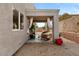 Outdoor patio features stylish furniture, plants, curtains and paver stones in the backyard at 2876 Strathallan Ave, Henderson, NV 89044