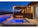 Beautiful backyard with a sparkling pool, modern spa, and outdoor fireplace under a pergola at 294 Besame Ct, Las Vegas, NV 89138