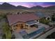 Backyard view featuring a pool, spa, covered patio, and outdoor kitchen perfect for entertaining and relaxation at 294 Besame Ct, Las Vegas, NV 89138