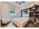 Cozy bedroom features a ceiling fan, window, built-in bookshelf and murphy bed at 294 Besame Ct, Las Vegas, NV 89138