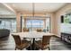 Chic dining area with views to the pool and desert landscape, adjacent to the bright and open kitchen at 294 Besame Ct, Las Vegas, NV 89138