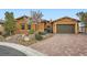 Attractive front exterior featuring well-maintained landscaping and a charming brick driveway leading to the two-car garage at 294 Besame Ct, Las Vegas, NV 89138