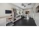 Spacious home gym with large windows, work area, TV, and exercise equipment at 294 Besame Ct, Las Vegas, NV 89138