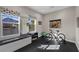 Home gym with large windows, bench seating, mountain views, and exercise equipment at 294 Besame Ct, Las Vegas, NV 89138