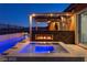 Backyard hot tub with fireplace and outdoor tv, perfect for relaxing and entertaining at 294 Besame Ct, Las Vegas, NV 89138