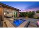 This beautiful backyard shows a hot tub with water features, steps from the sliding door to the bedroom at 294 Besame Ct, Las Vegas, NV 89138
