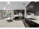 Modern kitchen featuring dark cabinetry, stainless steel appliances, and a large island with a sink and pendant lighting at 294 Besame Ct, Las Vegas, NV 89138