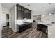 Well-lit kitchen with dark cabinets, mosaic backsplash, stainless steel appliances, and an open floorplan at 294 Besame Ct, Las Vegas, NV 89138