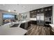 Spacious kitchen with an island, stainless steel appliances, dark cabinets, and a view to the outside patio area at 294 Besame Ct, Las Vegas, NV 89138