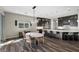 Open-concept kitchen with an island, dining area, modern lighting, stainless steel appliances, and dark cabinets at 294 Besame Ct, Las Vegas, NV 89138