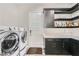 Well-equipped laundry room with modern washer, dryer, cabinetry and countertop at 294 Besame Ct, Las Vegas, NV 89138