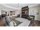 Cozy living room with a fireplace, plush seating, modern ceiling fan, and artwork, creating an inviting space at 294 Besame Ct, Las Vegas, NV 89138