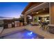This outdoor kitchen and dining area has comfortable seating and a direct entrance into the home at 294 Besame Ct, Las Vegas, NV 89138