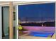 Relaxing outdoor space with a spa offering stunning city views at night at 294 Besame Ct, Las Vegas, NV 89138