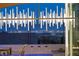 Night view of the pool, patio, and city skyline, framed by modern outdoor lighting and desert landscaping at 294 Besame Ct, Las Vegas, NV 89138