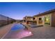 An inviting home features an outdoor pool, covered lounge, outdoor kitchen, and ample patio space at 294 Besame Ct, Las Vegas, NV 89138