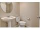 Clean half-bath featuring a white pedestal sink and a modern toilet at 3165 Brynley Ave, Henderson, NV 89044