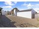 An open backyard featuring gravel landscaping and a covered patio, ideal for outdoor living and relaxation at 3672 Madrid St, Las Vegas, NV 89121