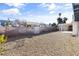 Wide backyard, featuring gravel ground cover, with fence and covered patios at 3672 Madrid St, Las Vegas, NV 89121