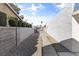 View of a backyard walkway and gravel ground cover between stone walls at 3672 Madrid St, Las Vegas, NV 89121