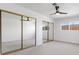 Bright bedroom with neutral carpet, a ceiling fan, and mirrored closet doors at 3672 Madrid St, Las Vegas, NV 89121