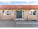 Up-close exterior featuring brick facade, arched windows and an ornate wrought iron security front door at 3672 Madrid St, Las Vegas, NV 89121
