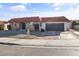 Single-story home featuring red tile roof, arched windows, front yard desert landscaping, and a gray attached garage at 3672 Madrid St, Las Vegas, NV 89121