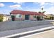 Single-story home showing desert front yard, brick facade, arched windows, and a striking red-tiled roof at 3672 Madrid St, Las Vegas, NV 89121