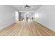 Open living space with light wood-look floors leads to a modern kitchen at 3672 Madrid St, Las Vegas, NV 89121