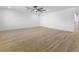 Spacious, bright living room featuring light wood flooring, white walls and ceiling fan at 3672 Madrid St, Las Vegas, NV 89121