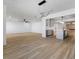 Spacious open-concept living area with wood floors leading to a modern kitchen and fireplace at 3672 Madrid St, Las Vegas, NV 89121