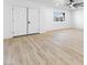 Bright living room featuring light wood flooring, white walls and a double door entryway at 3672 Madrid St, Las Vegas, NV 89121