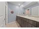 Bathroom featuring a double sink vanity, granite countertops, and modern fixtures at 3835 Berenices Ave, North Las Vegas, NV 89084