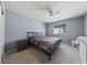 A cozy bedroom with soft carpet, a ceiling fan, and neutral-colored walls at 3835 Berenices Ave, North Las Vegas, NV 89084