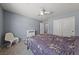 A cozy bedroom with soft carpet, a ceiling fan, and neutral-colored walls at 3835 Berenices Ave, North Las Vegas, NV 89084