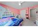 A vibrant bedroom with soft carpet, pink and blue walls and Disney Princess decorations at 3835 Berenices Ave, North Las Vegas, NV 89084