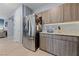 Kitchen with stainless steel refrigerator and modern wood cabinets with a stone countertop at 3835 Berenices Ave, North Las Vegas, NV 89084