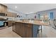 Spacious kitchen island with sink and barstool seating, stainless appliances, and sliding doors at 3835 Berenices Ave, North Las Vegas, NV 89084