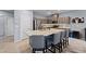 Modern kitchen with a granite island, stainless steel appliances, and breakfast bar seating at 3835 Berenices Ave, North Las Vegas, NV 89084