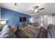 Open-concept living room with a blue accent wall, plush sofa, and modern furnishings at 3835 Berenices Ave, North Las Vegas, NV 89084