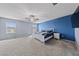 A spacious main bedroom featuring carpeted floors and a navy blue accent wall at 3835 Berenices Ave, North Las Vegas, NV 89084