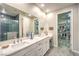 Neutral bathroom featuring double sinks and walk in closet with organizational shelving at 4273 Sunrise Flats St, Las Vegas, NV 89135