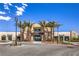 Attractive community clubhouse with palm trees, modern architecture, and paved parking at 4273 Sunrise Flats St, Las Vegas, NV 89135