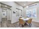 Dining area featuring a modern chandelier, plantation shutters, and views into the kitchen at 4273 Sunrise Flats St, Las Vegas, NV 89135