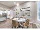 Cozy dining area with a round table, views to kitchen, and modern decor at 4273 Sunrise Flats St, Las Vegas, NV 89135