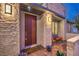 Inviting front door with covered entry, stone accents, and stylish outdoor lighting at 4273 Sunrise Flats St, Las Vegas, NV 89135